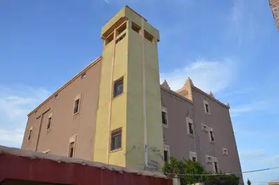 a building with a tower on the side of it at Kasbah Tasseurte in Kalaat MGouna