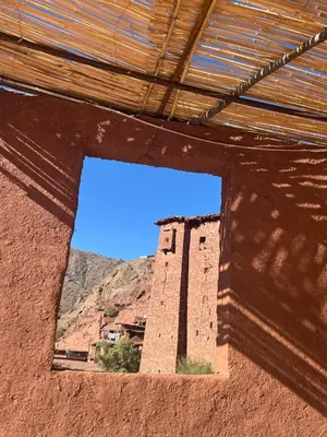 a window in a building with a view of a mountain at Gite Megdaz Ouhadouch in Megdaz