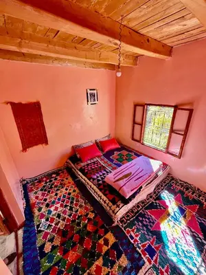 a small room with a bed and a rug at Gite Megdaz Ouhadouch in Megdaz