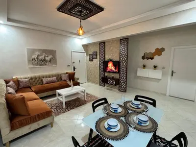 a living room with a couch and a table at Appartement 2 Chambres à Hamria Meknès in Meknès