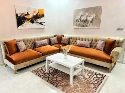 a living room with a couch and a table at Appartement 2 Chambres à Hamria Meknès in Meknès