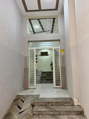 a hallway with stairs leading into a building at Appartement 2 Chambres à Hamria Meknès in Meknès
