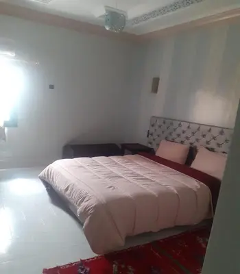 a bedroom with a large bed in a room at Hotel Ksar Kaissar in Kalaat MGouna