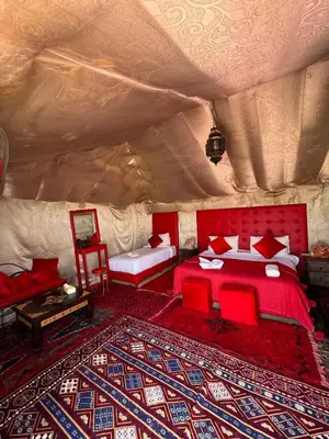 a bedroom with a bed in a tent at Dune Glamp Camp in Merzouga