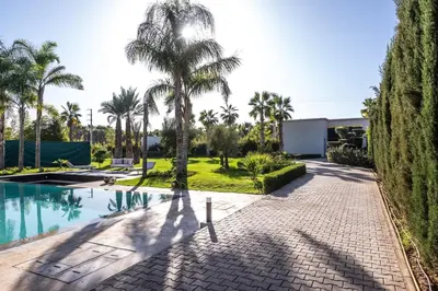 a resort with a swimming pool and palm trees at Villa Stella! Élégante & piscine sans vis à vis in Marrakech