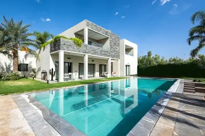 a swimming pool in front of a villa at Villa Stella! Élégante & piscine sans vis à vis in Marrakech
