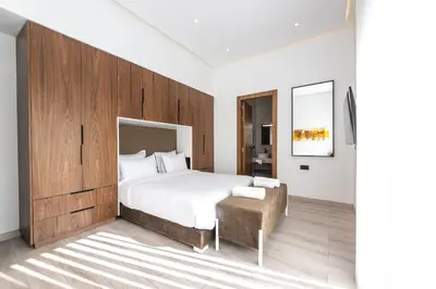 a bedroom with a large bed with a wooden wall at Villa Stella! Élégante & piscine sans vis à vis in Marrakech