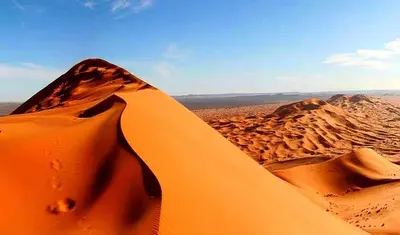 a view of a desert with sand and rocks at luxury camp desert ideal in Merzouga