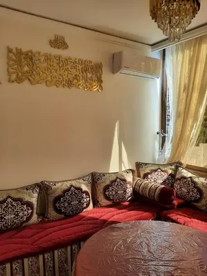 a room with a couch with pillows and a window at Dar Igri in Ourika