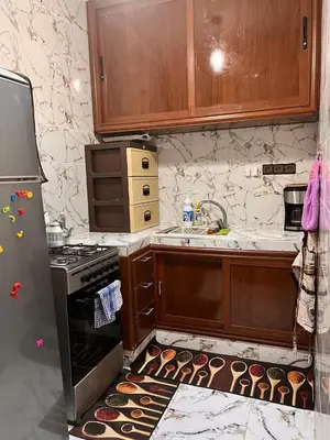 a kitchen with an oven with cupcakes on the floor at Dar Igri in Ourika