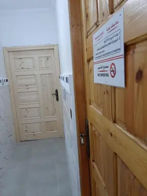 a bathroom with a door with a sign on it at Dar Igri in Ourika