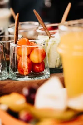 a table topped with glasses of fruit and drinks at Touareg spirit luxury Camp in Merzouga
