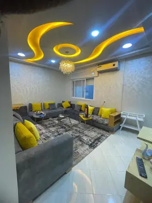 a living room with a couch and yellow pillows at Dans un bâtiment in Meknès