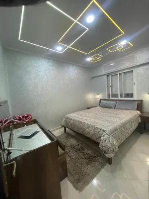 a bedroom with a bed and a desk and a bed sidx sidx sidx at Dans un bâtiment in Meknès