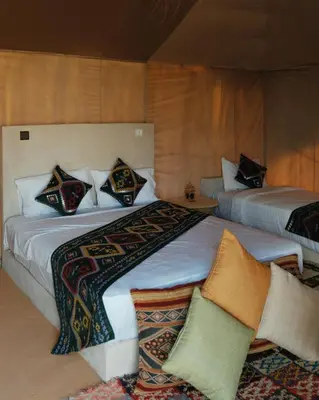 a bedroom with two beds with pillows on them at Infinity Camp Morocco in Mfis