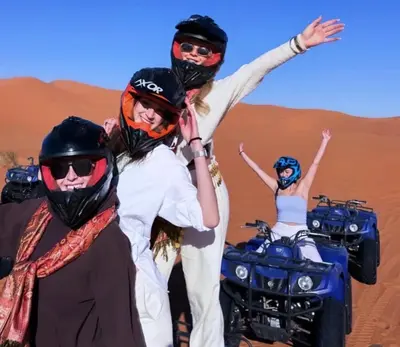 a group of people on motorcycles in the desert at Incredible luxury Camp in Merzouga