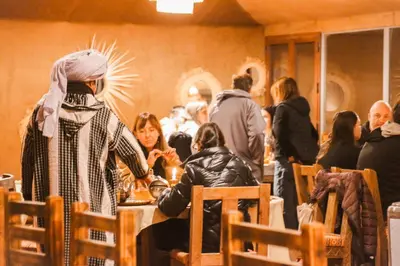 a group of people standing around a table in a room at Incredible luxury Camp in Merzouga