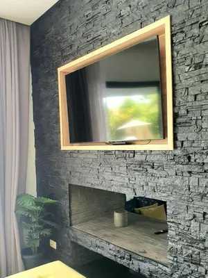 a television on top of a brick fireplace at Not overlooked villa with heated pool 4 suites in Oulad Akkou