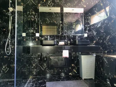 a black bathroom with two sinks and a mirror at Not overlooked villa with heated pool 4 suites in Oulad Akkou