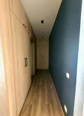 an empty closet with wooden cabinets and a blue wall at Not overlooked villa with heated pool 4 suites in Oulad Akkou