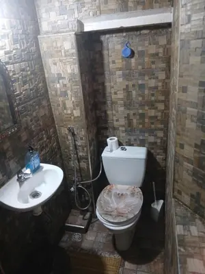 a bathroom with a toilet and a sink at Dar lmallouki 2 in Fès