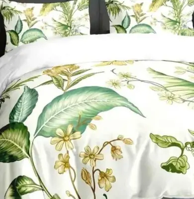 a bed with a white pillow with flowers and leaves at Belle vue Belle situation in Ifrane