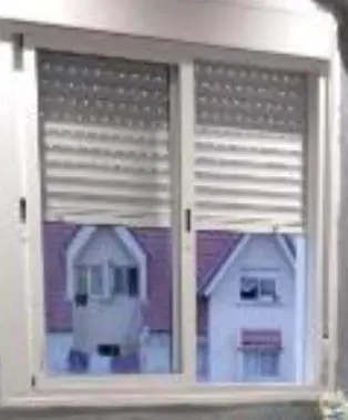 a window of a house with a white house at Belle vue Belle situation in Ifrane