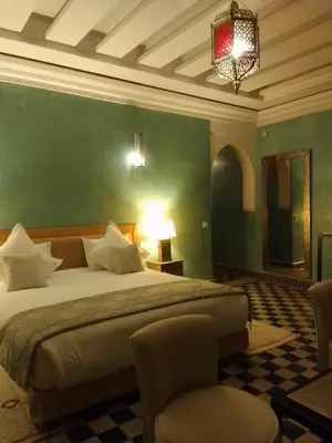 a bedroom with a large bed with a green wall at Maria in Najem