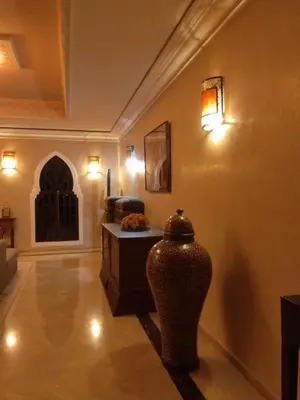 a room with a vase on the wall with lights at Maria in Najem