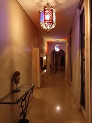 a hallway with a table and a chandelier at Maria in Najem