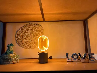 a light on a table with a mirror and love sign at Pikala Home in Ourika