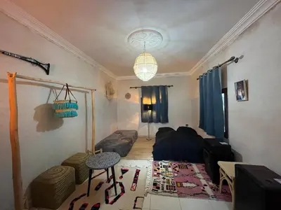 a living room with a bed and a table at Pikala Home in Ourika