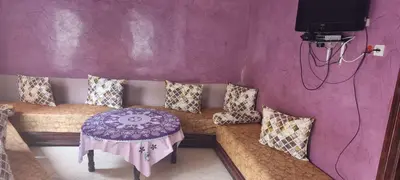 a living room with a couch with a table at منزل باهية in Moulay Yacoub