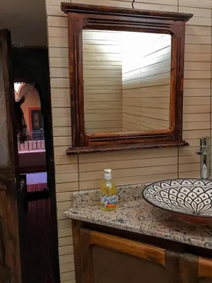 a bathroom with a sink and a mirror at Riad La Perle Tamnougalte in Agdz
