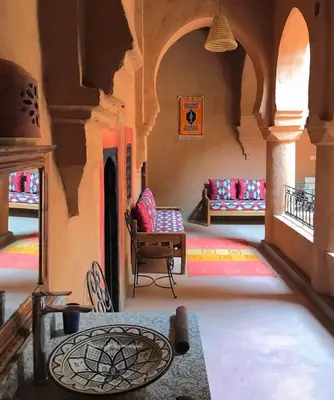 a living room with a couch and a table at Riad La Perle Tamnougalte in Agdz