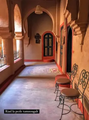 an empty room with chairs in a building at Riad La Perle Tamnougalte in Agdz