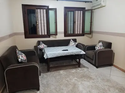 a living room with two couches and a table at Appartement Fascinant à Meknès in Meknès