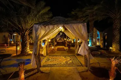 a tent in the middle of a street at night at Sahara Garden Luxury Camp in Merzouga