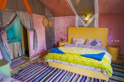 a bedroom with a bed in a tent at Sahara Garden Luxury Camp in Merzouga