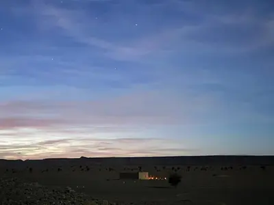 a group of people in the desert at dusk at Guest House For Rent Merzane in Merzane