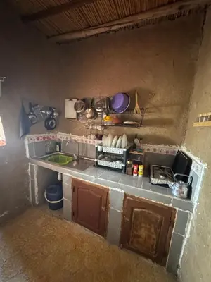 a small kitchen with a sink and a counter top at Guest House For Rent Merzane in Merzane