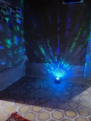 a room with a blue and green lights on the floor at Guest House For Rent Merzane in Merzane