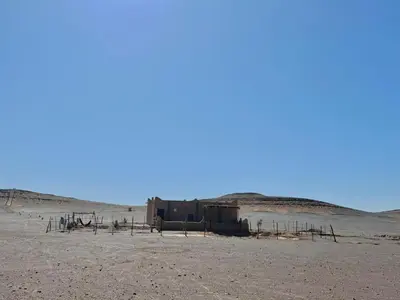 a building in the middle of the desert at Guest House For Rent Merzane in Merzane