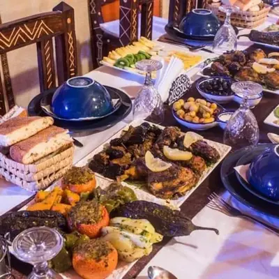 a table with a buffet of food on it at Dream Desert Camp in Merzouga