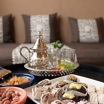 a table with several different types of desserts on it at Dream Desert Camp in Merzouga