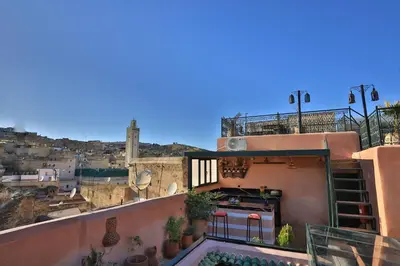 a balcony of a building with a swimming pool at Riad Fes la Mama - Rooftop in Fès