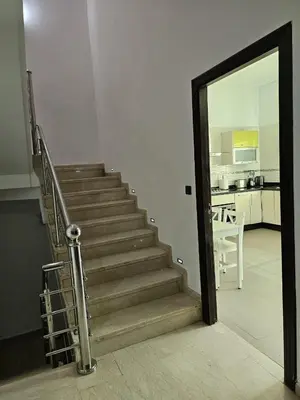 a staircase leading to a living room and a kitchen at Villa in Fès