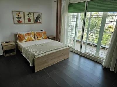 a bedroom with a bed and a large window at Villa in Fès