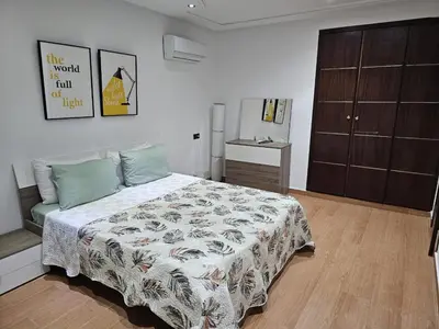 a bedroom with a bed and a dresser at Villa in Fès