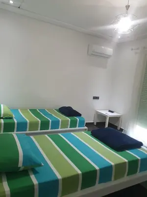 a bedroom with two beds and a table at Villa in Fès